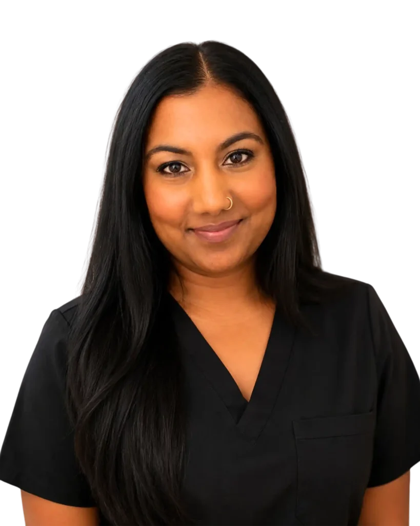 Smiling woman in black scrubs with long dark hair, against a black background.